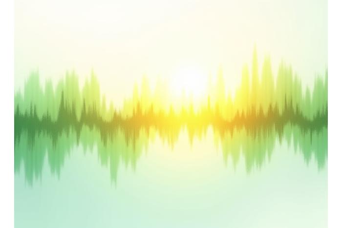 Visualisation abstrait de graphiques d'ondes sonores synchronisées et harmonieuses sur un fond lumineux.